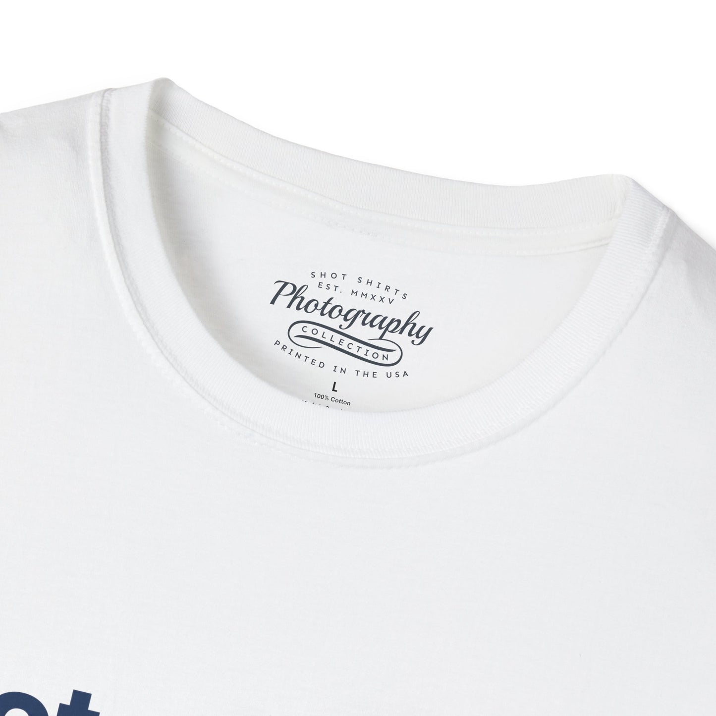 White t-shirt with a photography-themed label on a white background