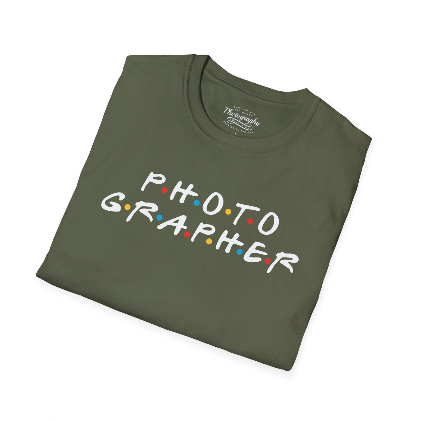 Folded green t-shirt with 'PHOTOGRAPHER' text on a white background