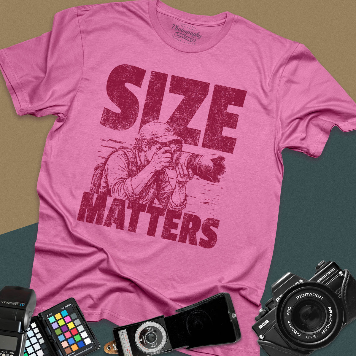 An azalea t-shirt featuring a distressed graphic of a photographer looking through a camera with a huge telephoto lens, with the words "SIZE" and "MATTERS" in bold between them.