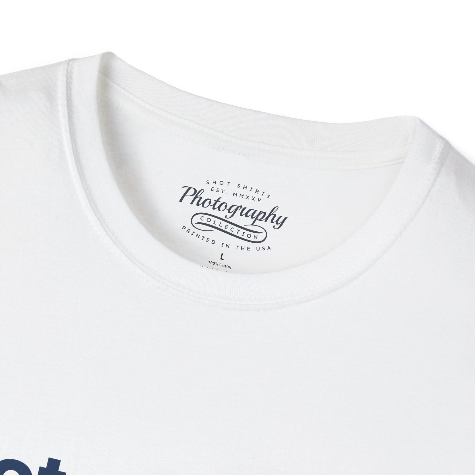 White t-shirt with a photography-themed label on a white background