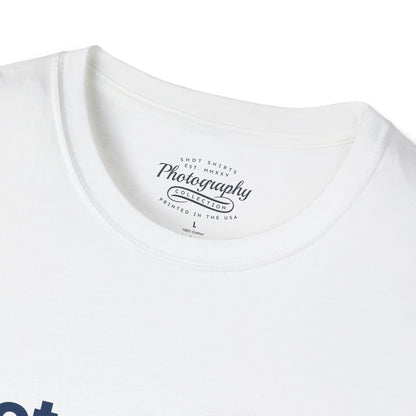 White t-shirt with a photography-themed label on a white background