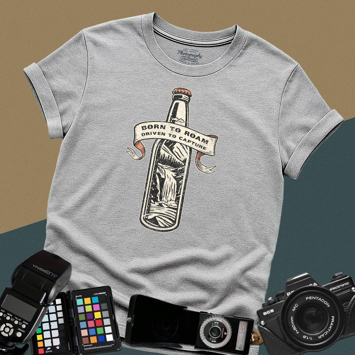 Vintage sport-grey graphic t-shirt featuring a bottle with a mountain landscape and the text "Born to Roam Driven to Capture" for travel photographers.