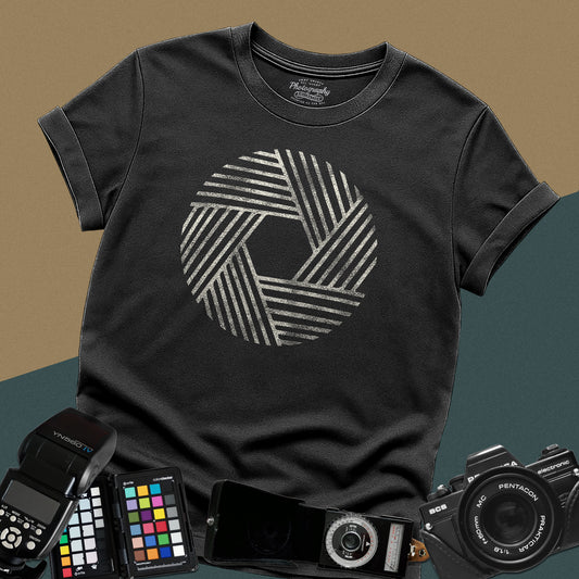 Heavy distressed Black t-shirt featuring a large geometric circle camera aperture shutter blade graphic made of abstract diagonal line art.