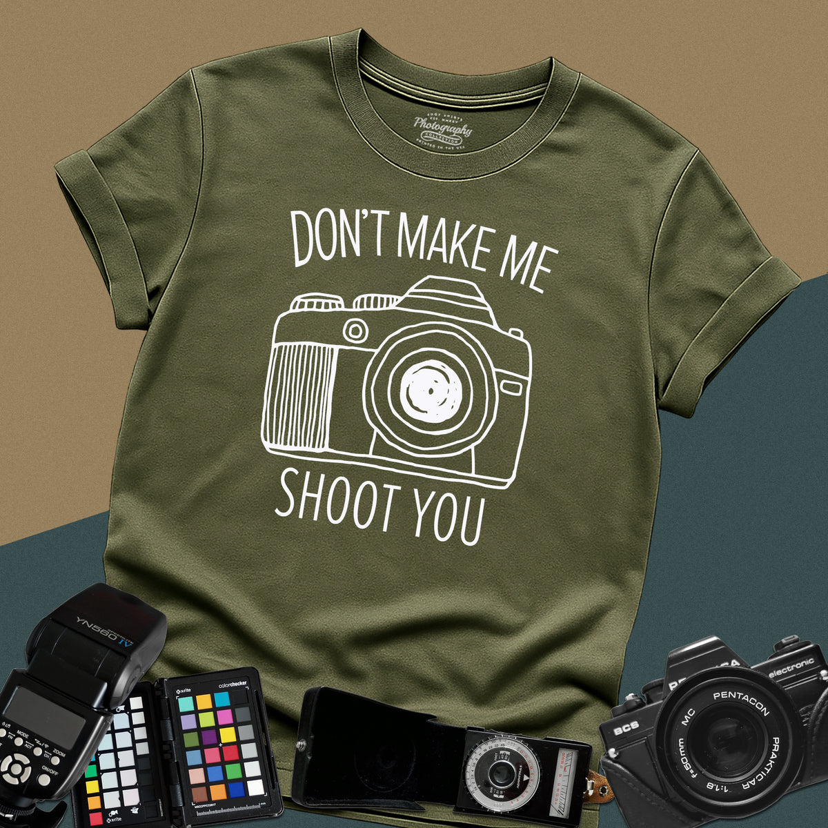Heavy distressed military-green t-shirt featuring a detailed retro DSLR camera graphic with a funny, sarcastic typography quote for professional visual creators.