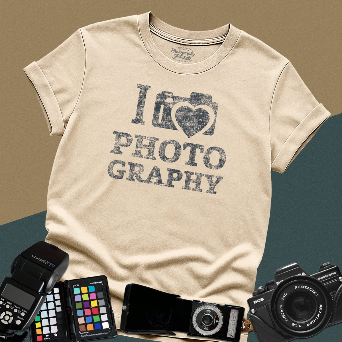 Heavy distressed sand t-shirt featuring a retro camera icon with an integrated heart silhouette and bold split typography text "I Love Photography".