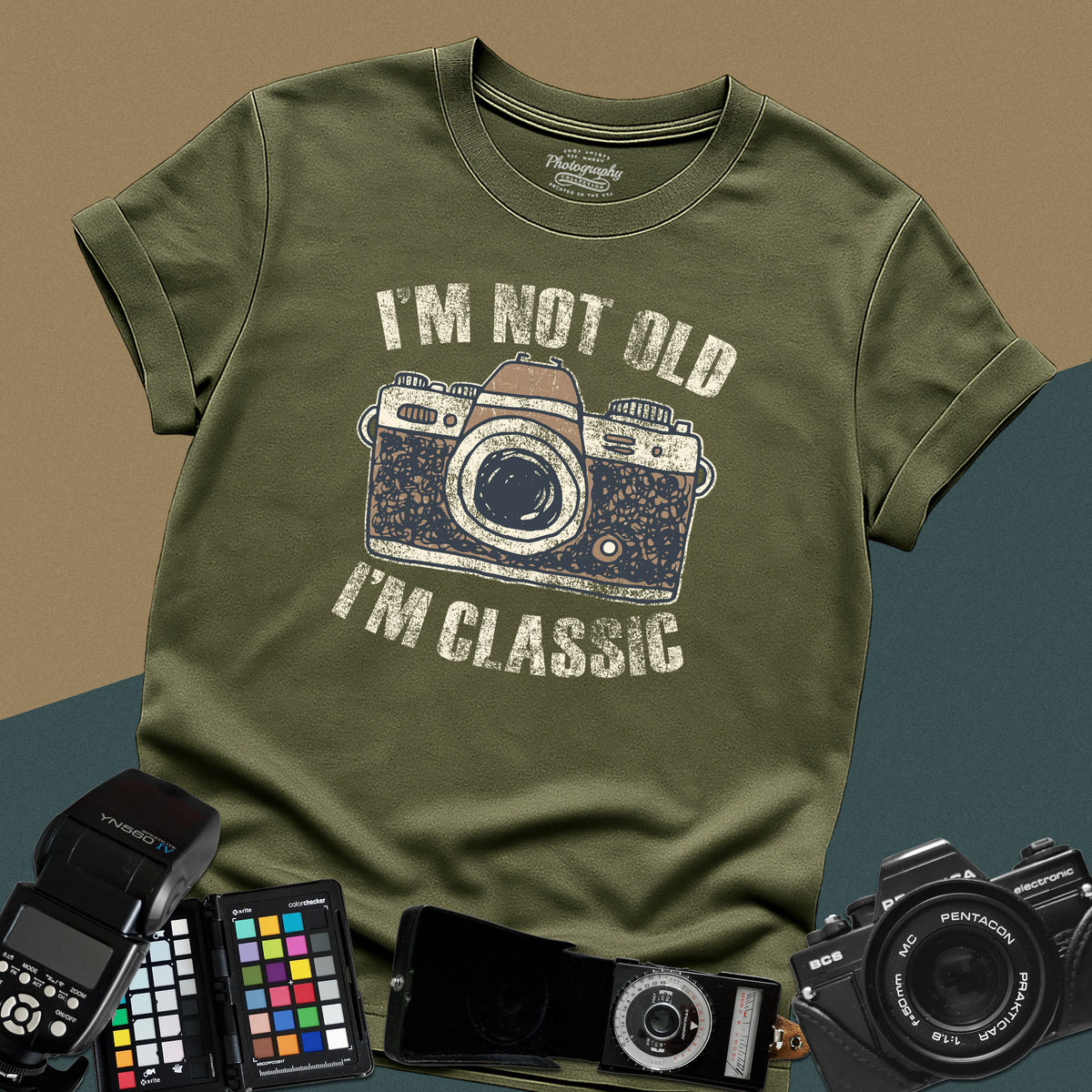 Heavy distressed military-green t-shirt featuring a retro film camera graphic with arched text "I'm Not Old, I'm Classic" for professional analog photographers.