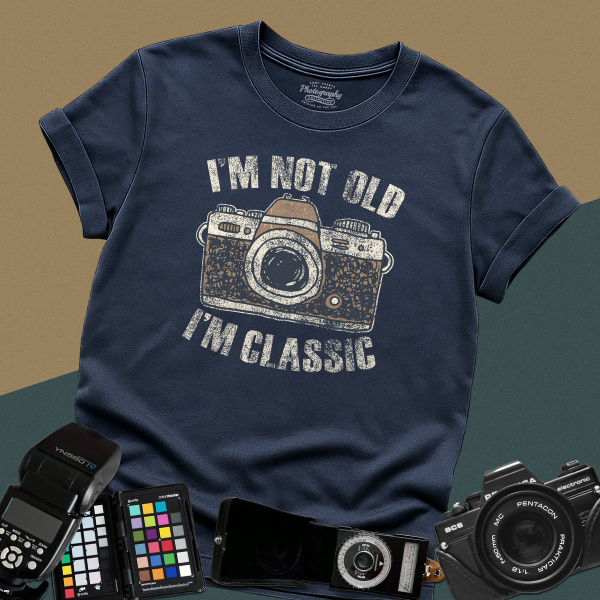 Heavy distressed navy-blue t-shirt featuring a retro film camera graphic with arched text "I'm Not Old, I'm Classic" for professional analog photographers.
