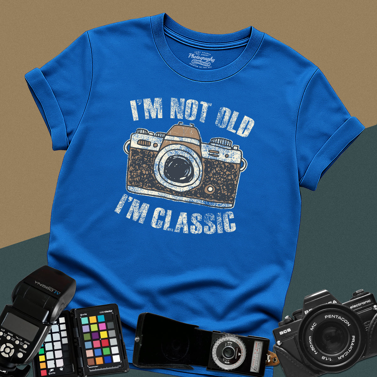 Heavy distressed royal-blue t-shirt featuring a retro film camera graphic with arched text "I'm Not Old, I'm Classic" for professional analog photographers.