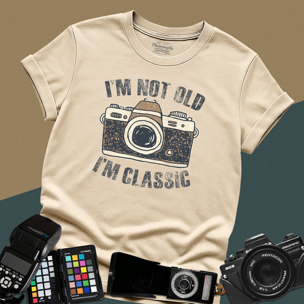 Heavy distressed sand t-shirt featuring a retro film camera graphic with arched text "I'm Not Old, I'm Classic" for professional analog photographers.