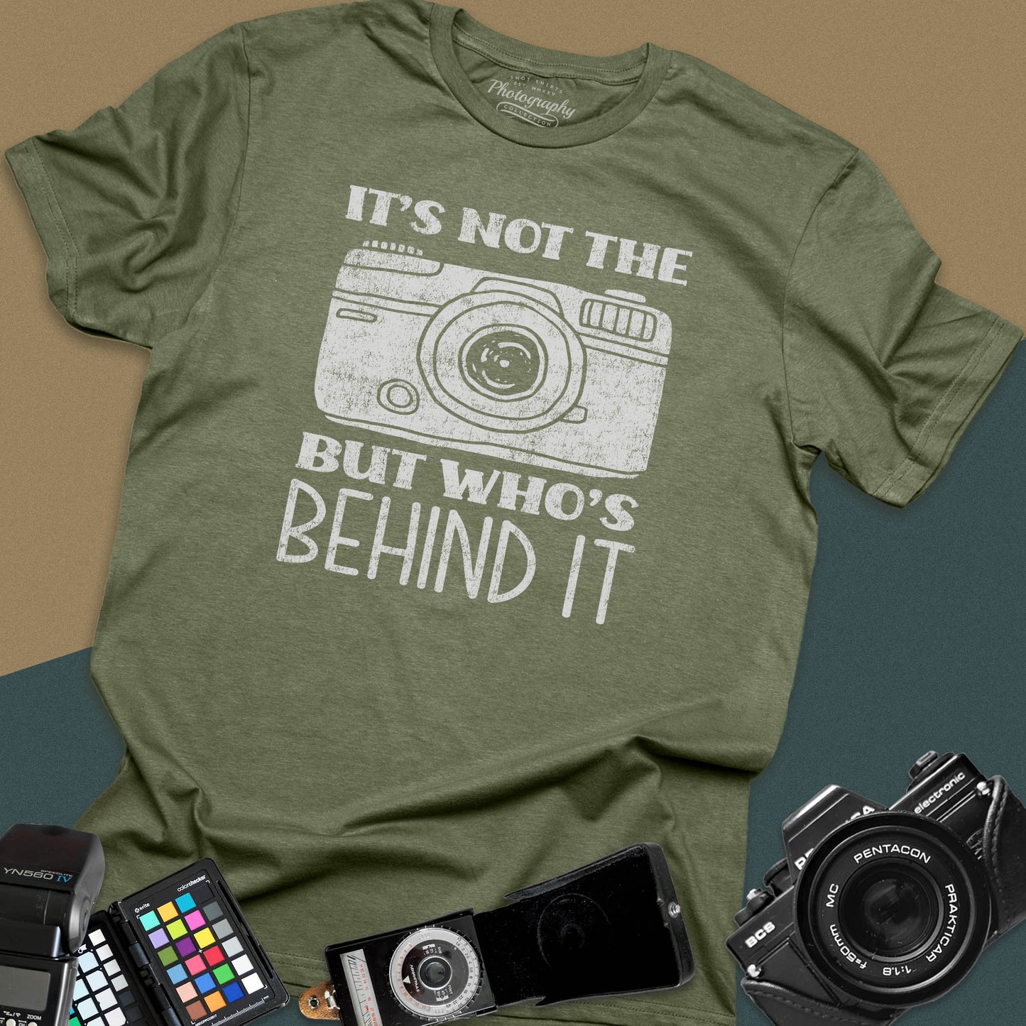 Distressed military-green t-shirt featuring a vintage rangefinder camera illustration with a bold retro typography quote for professional visual creators.