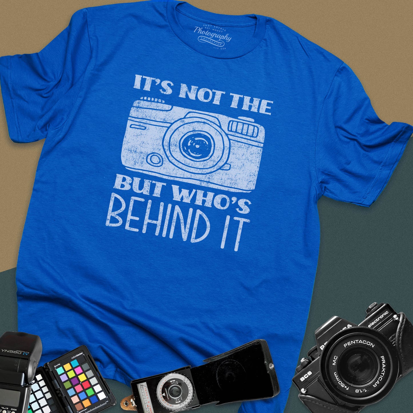 Distressed royal-blue t-shirt featuring a vintage rangefinder camera illustration with a bold retro typography quote for professional visual creators.