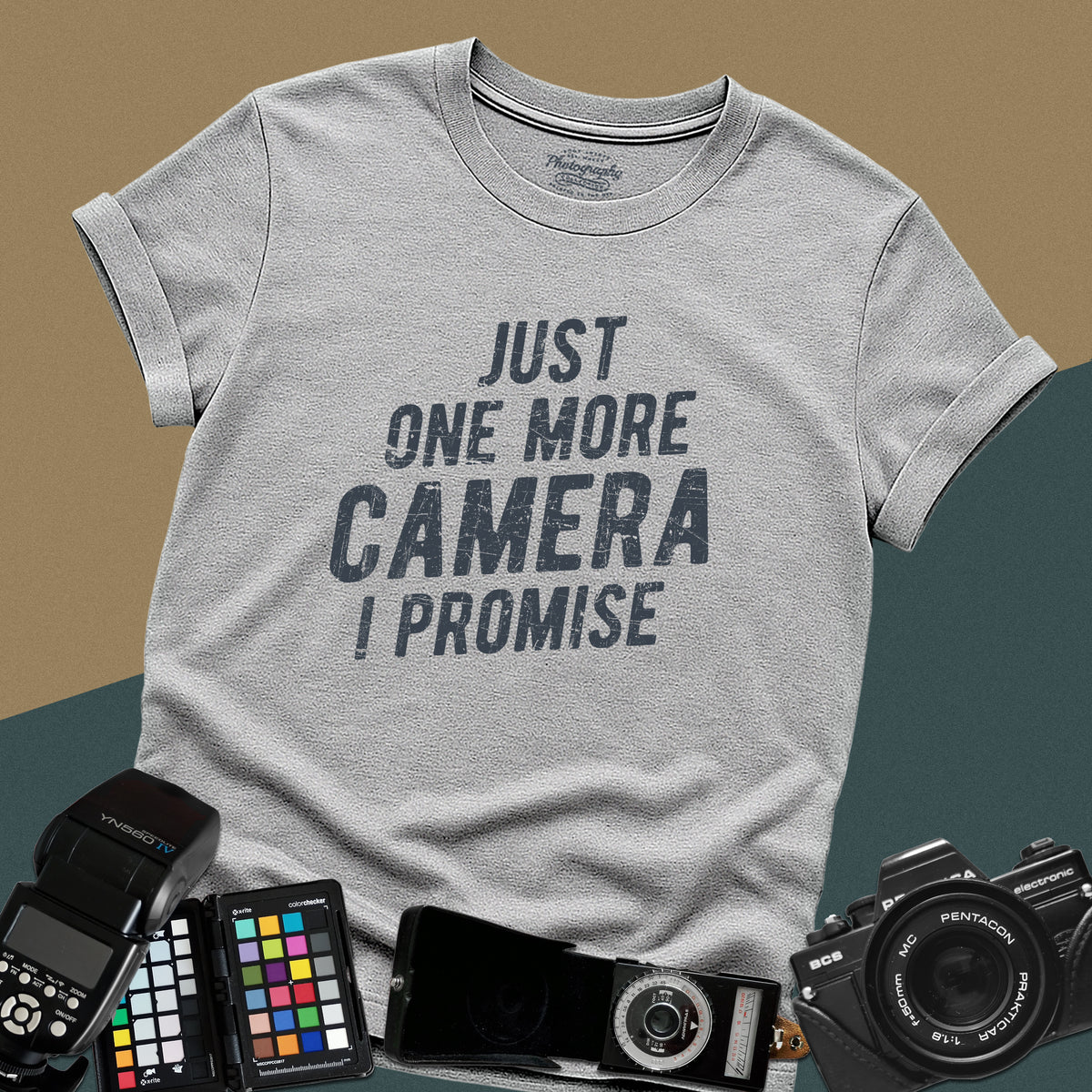 A sport-grey t-shirt featuring a distressed typography design that reads "JUST ONE MORE CAMERA I PROMISE" in bold letters across the chest.