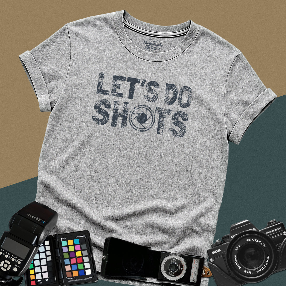 Heavy distressed sport-grey t-shirt featuring bold retro typography text "Let's Do Shots" with a camera aperture lens icon inside the letter O.