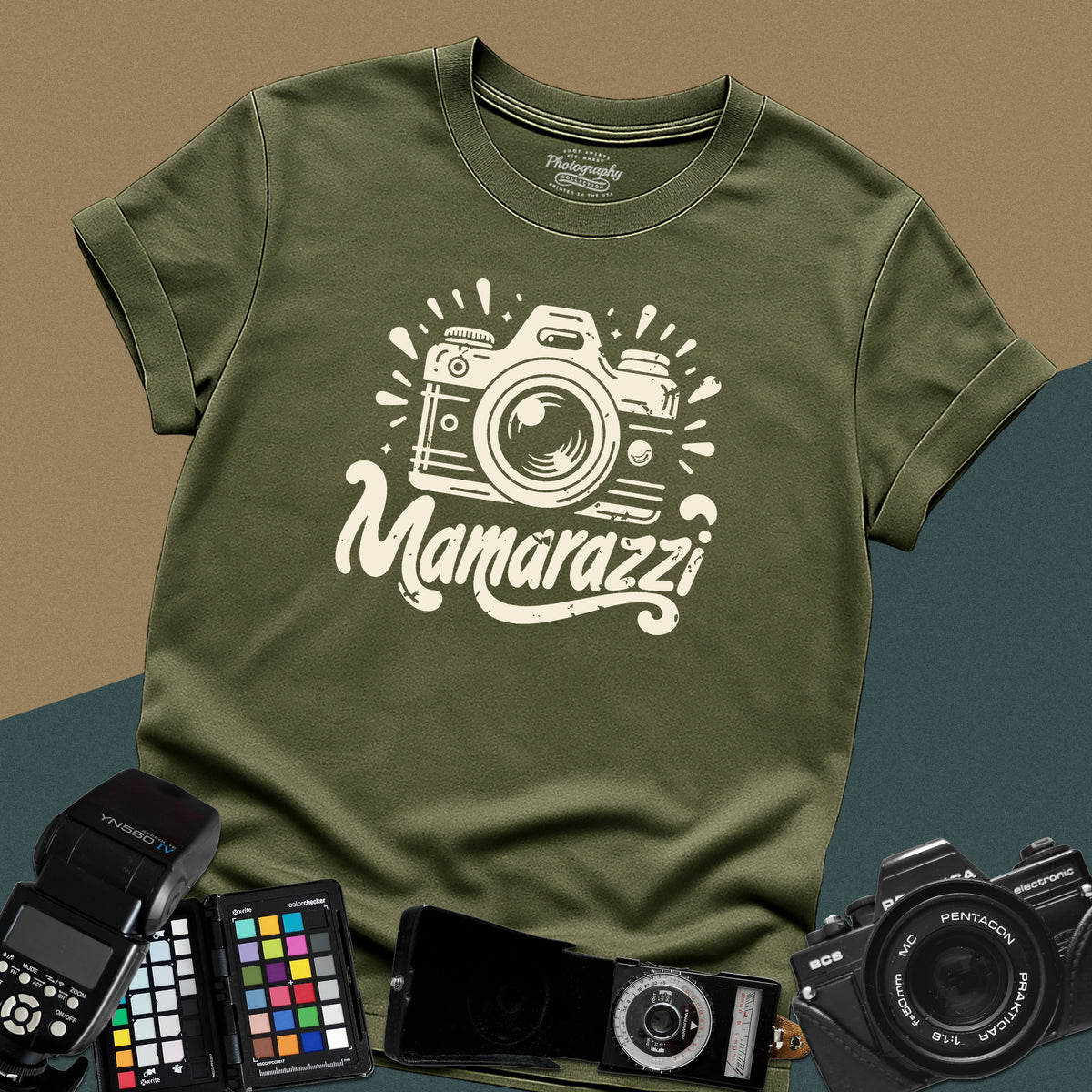 A military-green t-shirt featuring a distressed vintage camera graphic with sparkles and the stylized text "Mamarazzi" written in a retro script font across the chest.