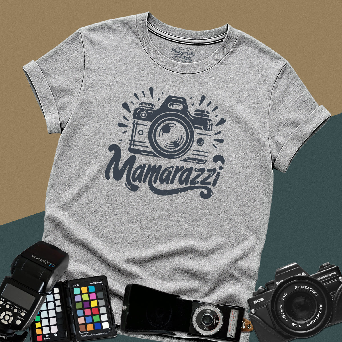 A sport-grey t-shirt featuring a distressed vintage camera graphic with sparkles and the stylized text "Mamarazzi" written in a retro script font across the chest.