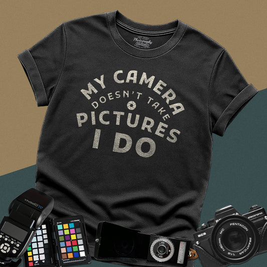 Minimalist black t-shirt featuring the arched vintage text "My Camera Doesn't Take Pictures I Do" with an aperture icon for photographers.