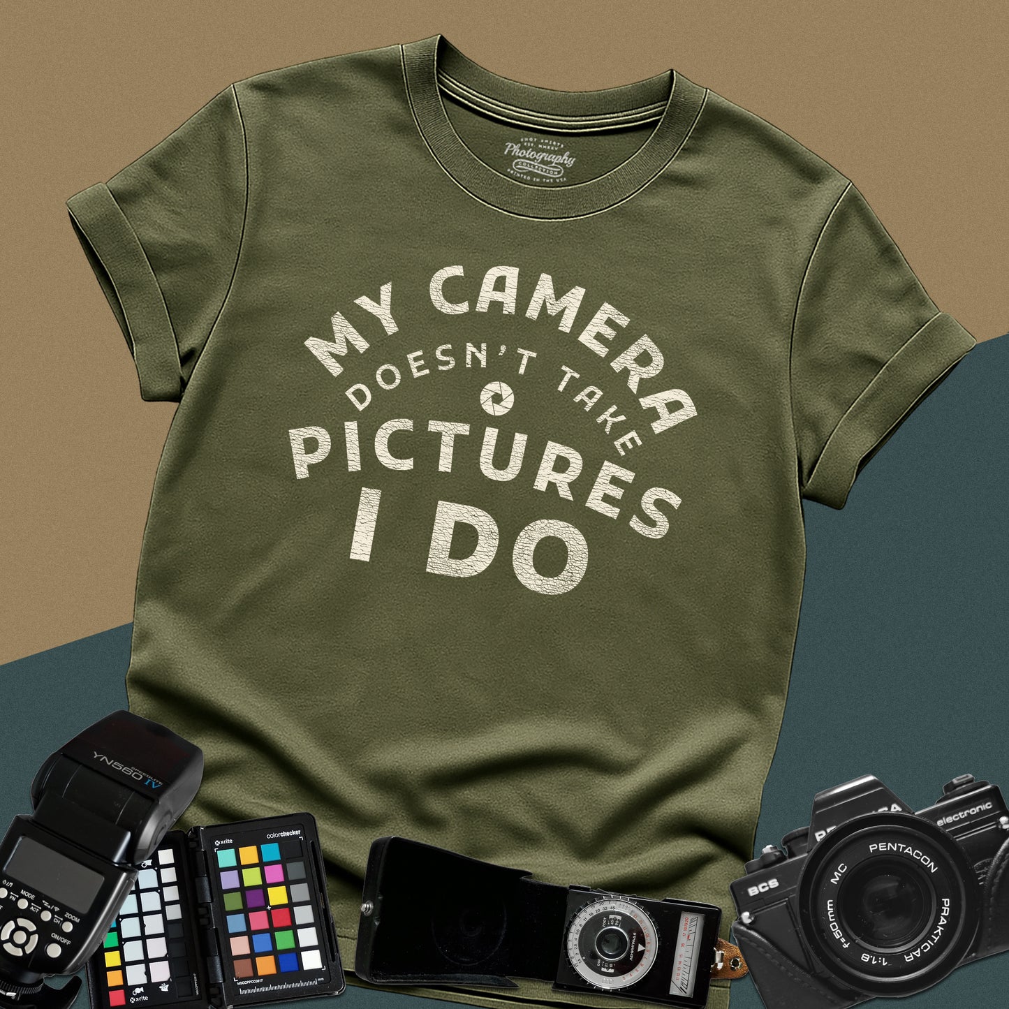 Minimalist military-green t-shirt featuring the arched vintage text "My Camera Doesn't Take Pictures I Do" with an aperture icon for photographers.
