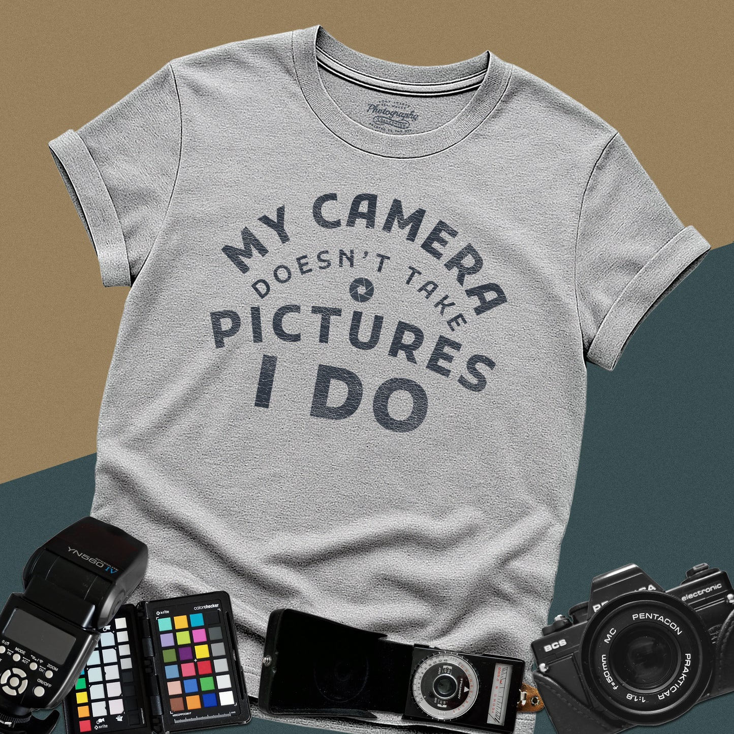 Minimalist sport-grey t-shirt featuring the arched vintage text "My Camera Doesn't Take Pictures I Do" with an aperture icon for photographers.