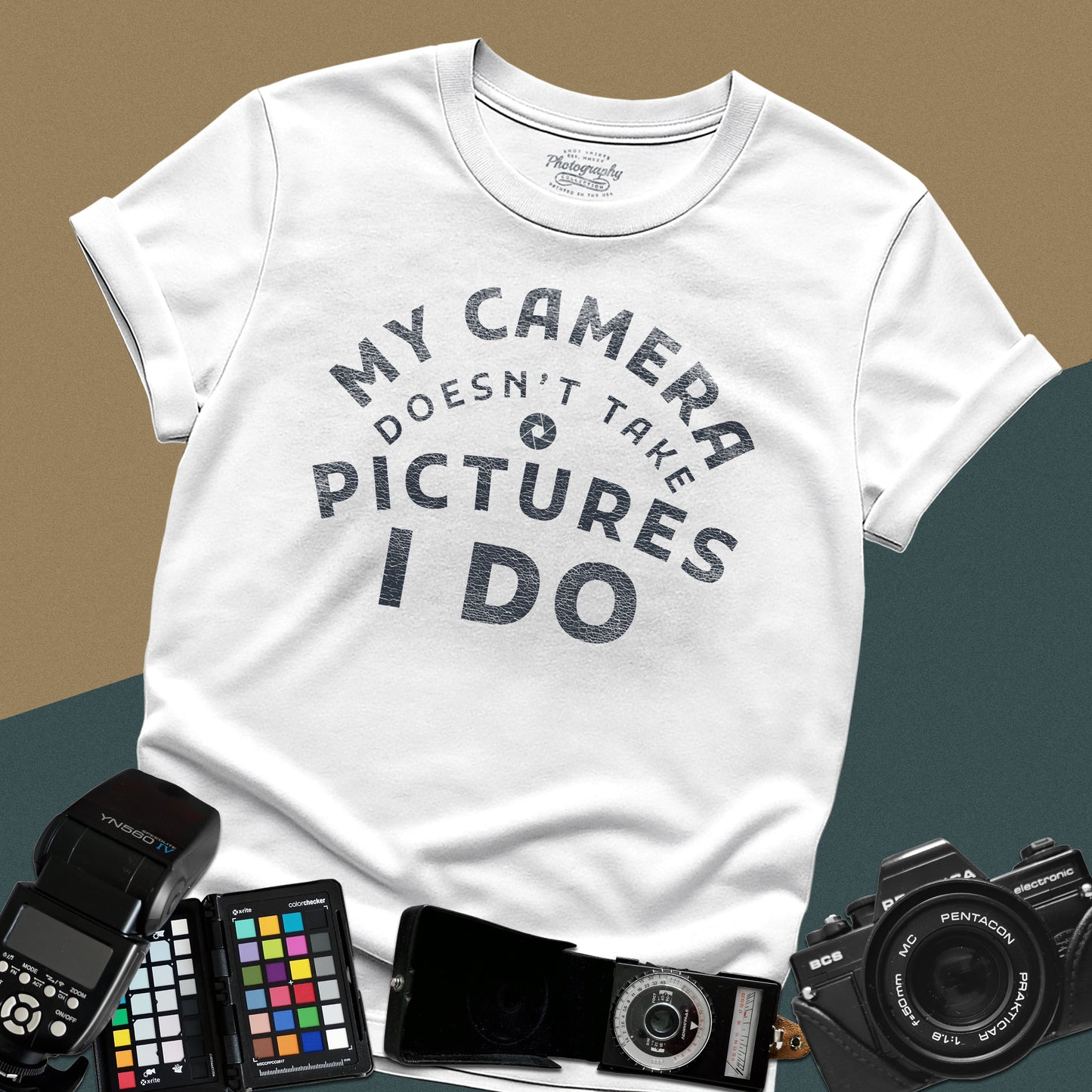 Minimalist white t-shirt featuring the arched vintage text "My Camera Doesn't Take Pictures I Do" with an aperture icon for photographers.