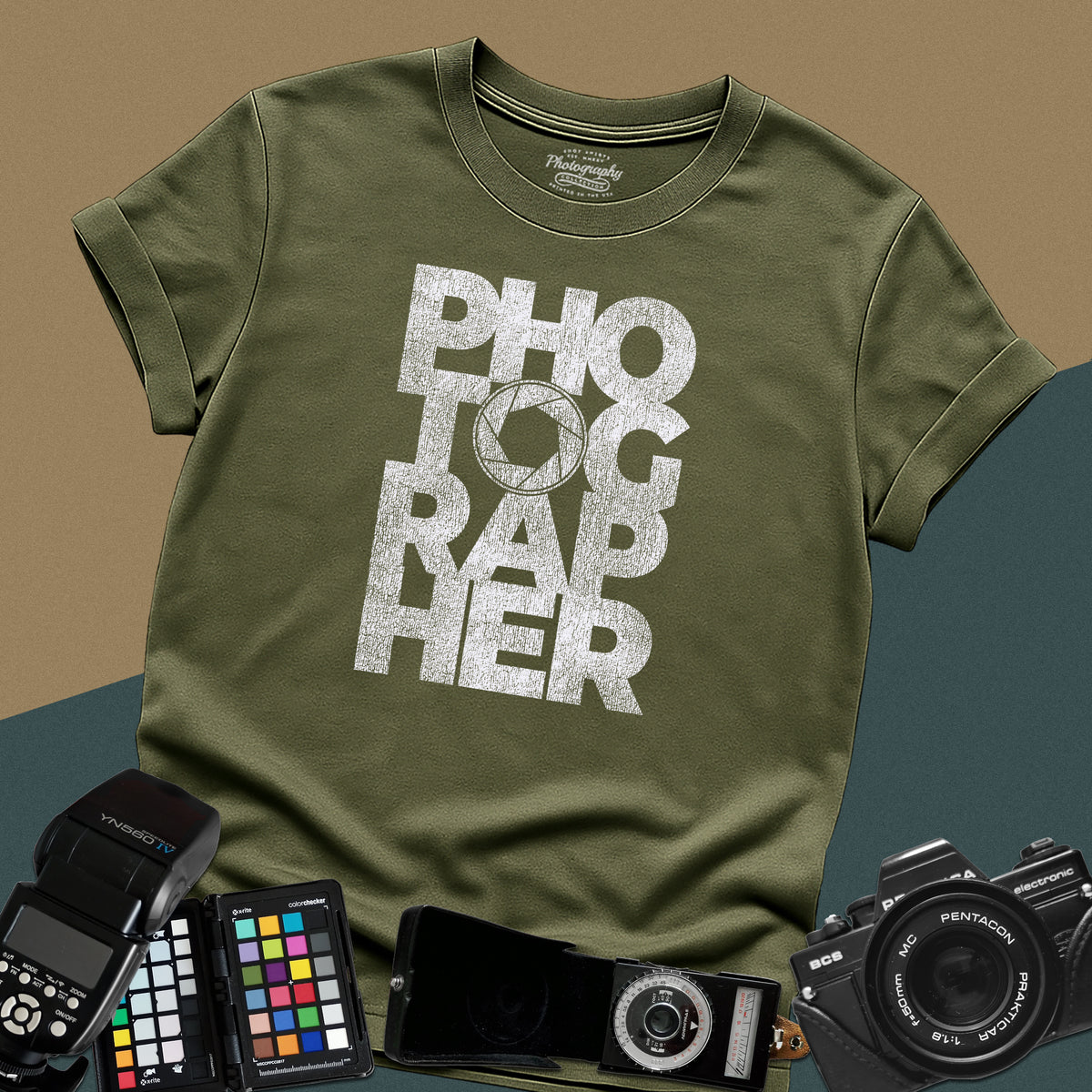 Clean military-green t-shirt featuring a geometric bold block typography design spelling photographer with a camera aperture lens icon inside the letter O.