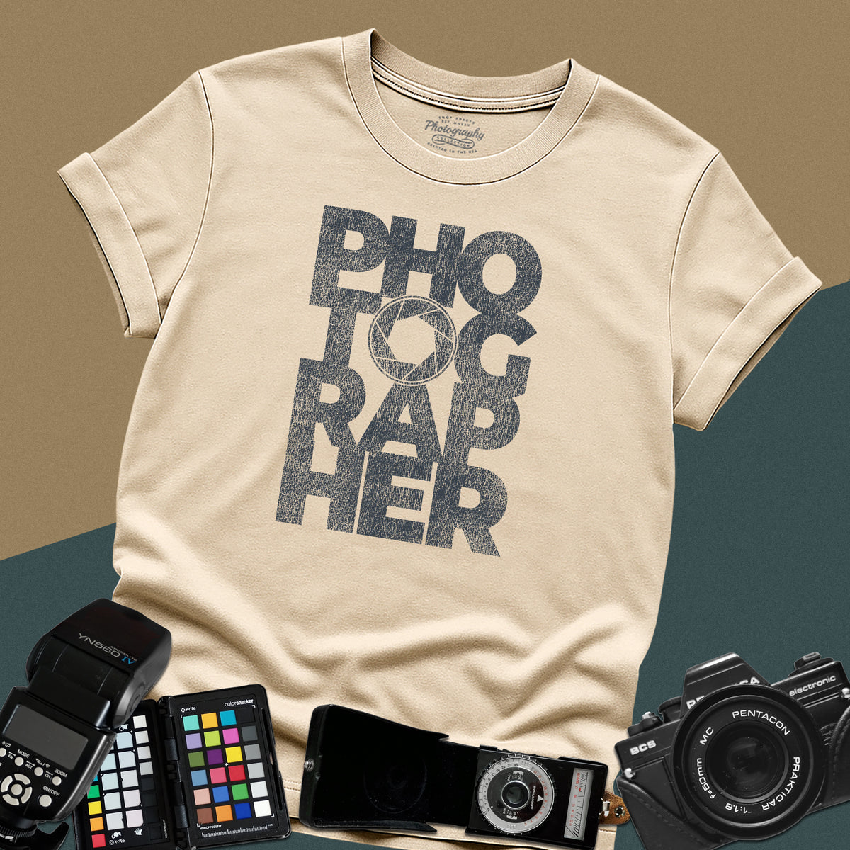 Clean sand t-shirt featuring a geometric bold block typography design spelling photographer with a camera aperture lens icon inside the letter O.