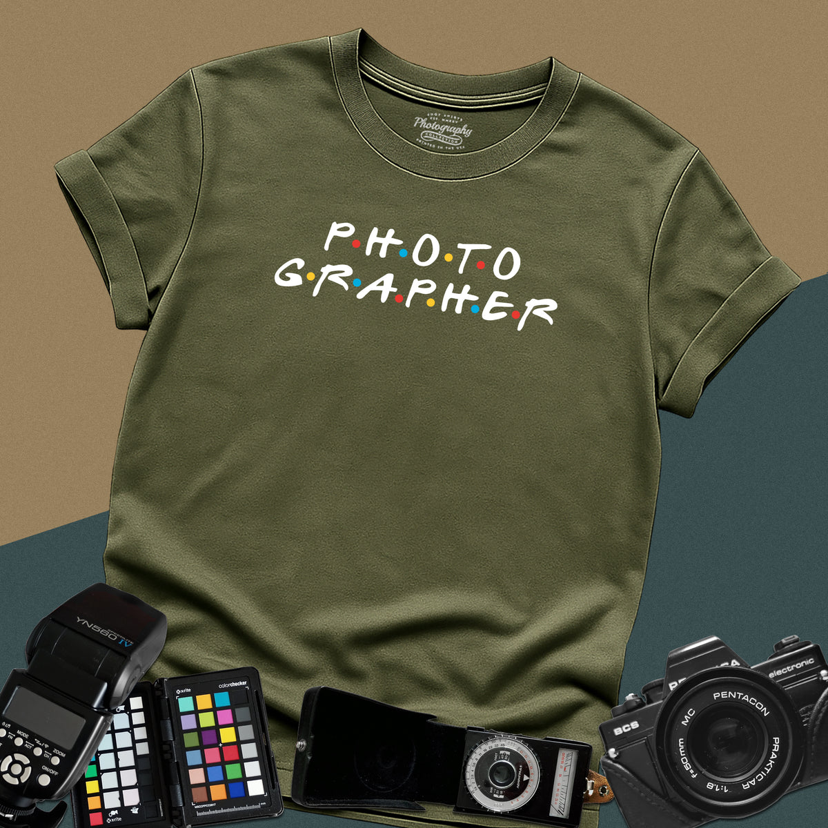 Clean military-green t-shirt featuring a funny photographer typography parody inspired by the classic nineties television show font with colorful dots.