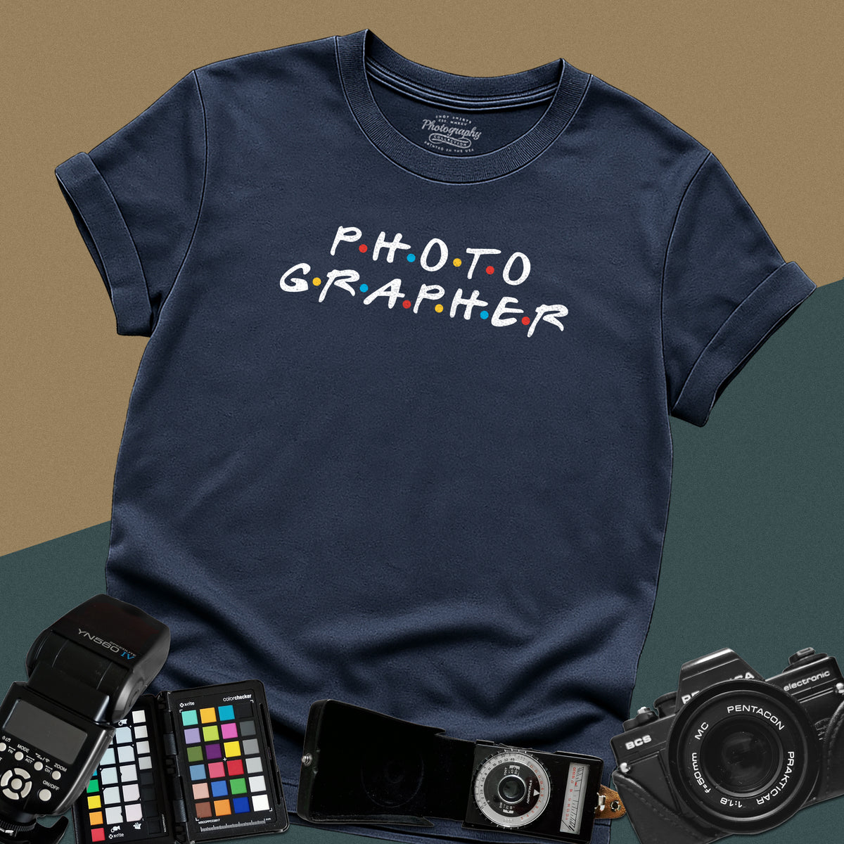 Clean navy-blue t-shirt featuring a funny photographer typography parody inspired by the classic nineties television show font with colorful dots.