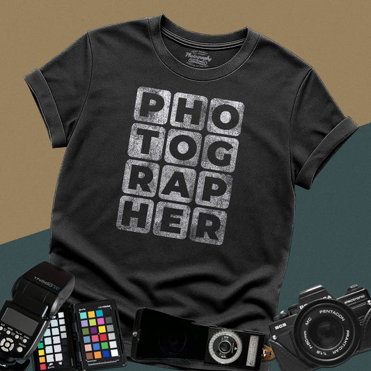 Heavy distressed black t-shirt featuring a modern geometric typography block layout spelling the word photographer with a vintage grunge texture.