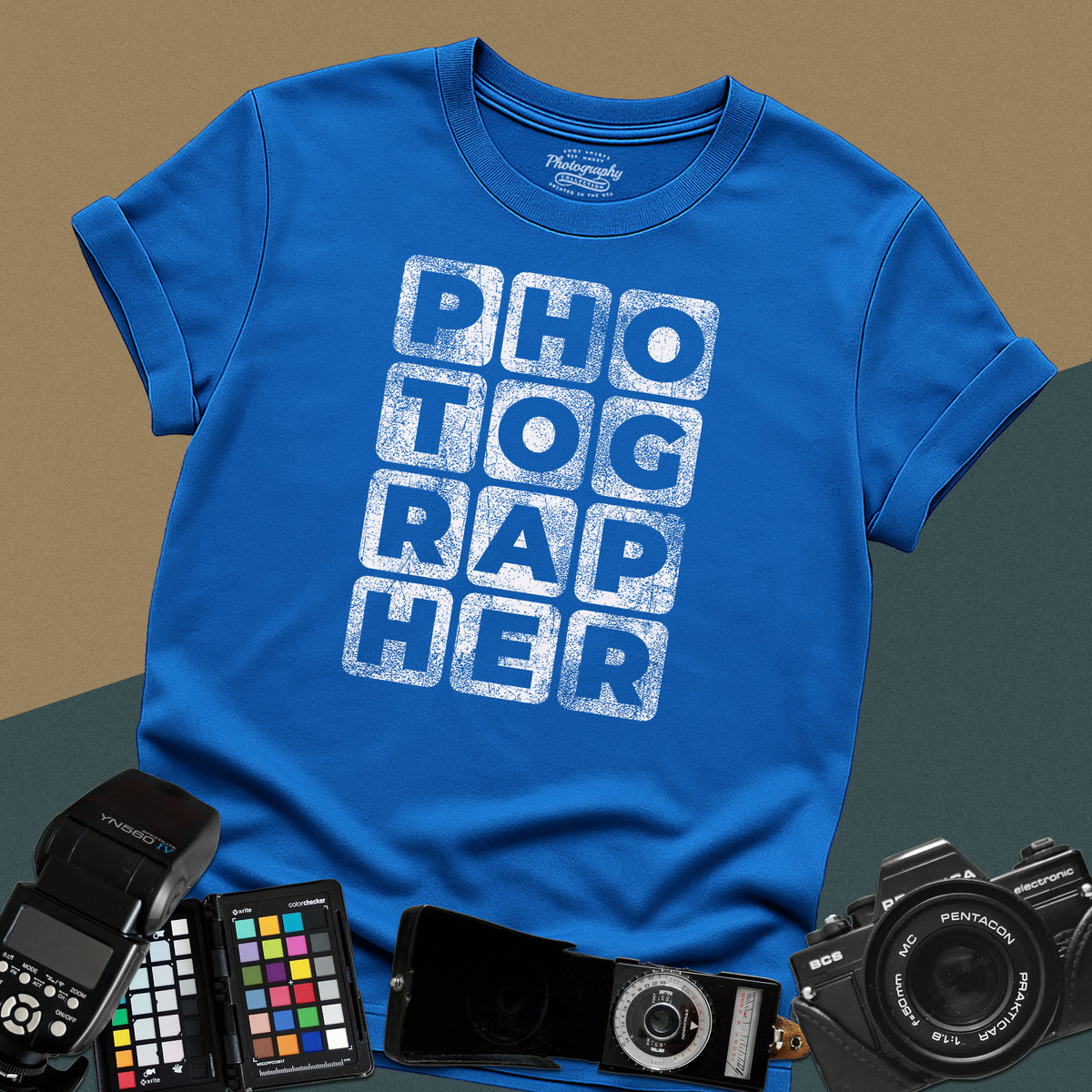 Heavy distressed royal-blue t-shirt featuring a modern geometric typography block layout spelling the word photographer with a vintage grunge texture.