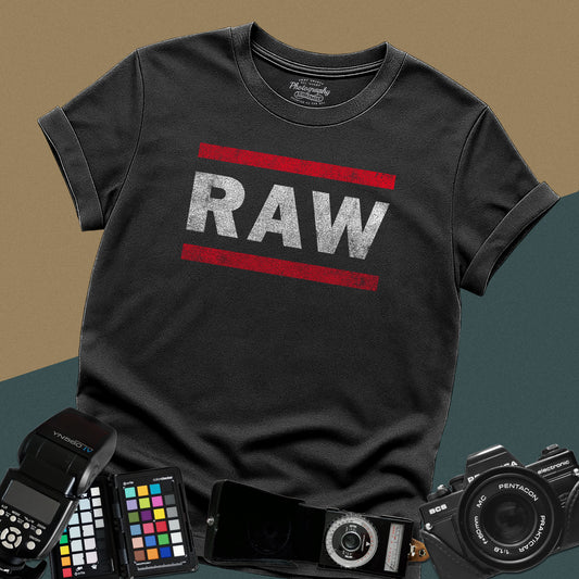 Distressed black t-shirt featuring a textured RAW photography file format typography design inspired by a classic retro sports entertainment wrestling show logo.