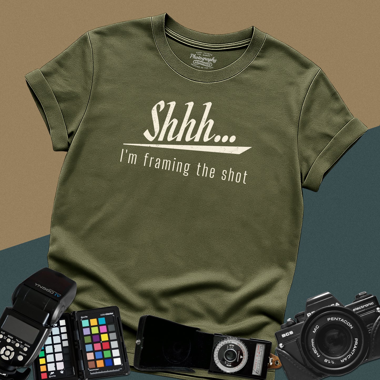 Minimalist military-green t-shirt featuring the distressed vintage text "Shhh... I'm framing the shot" for professional portrait photographers.