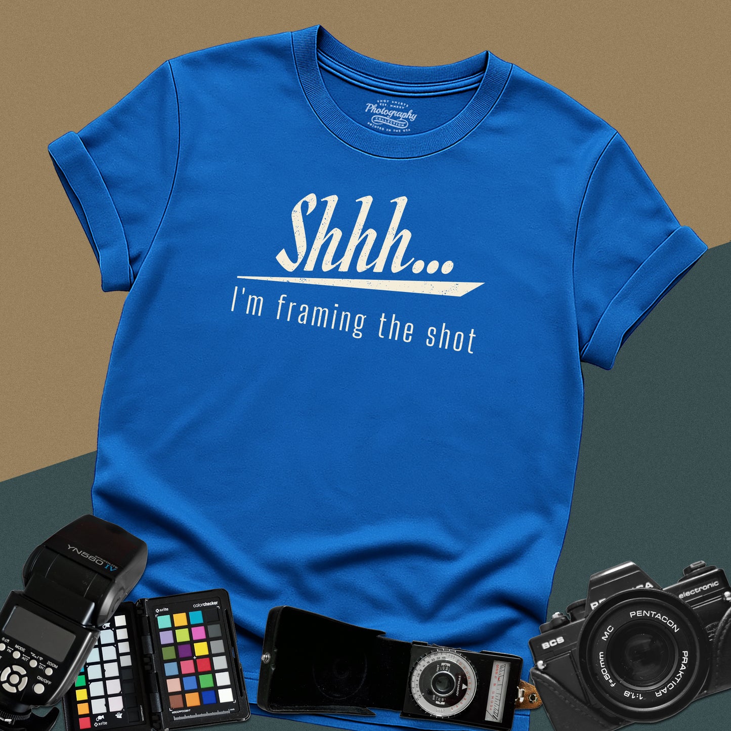Minimalist royal-blue t-shirt featuring the distressed vintage text "Shhh... I'm framing the shot" for professional portrait photographers.