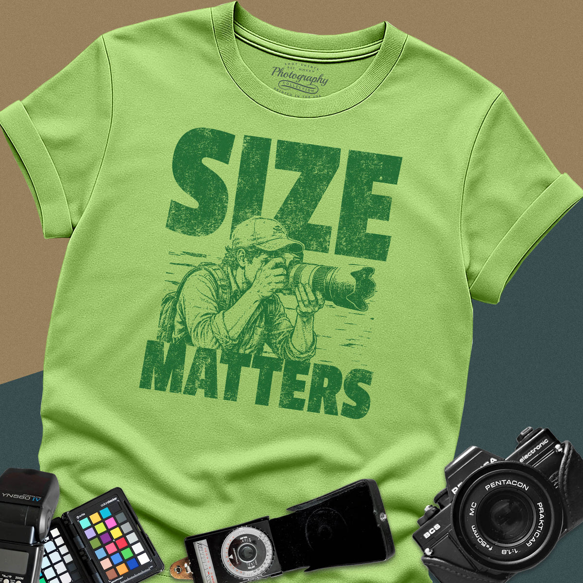 A lime green t-shirt featuring a distressed graphic of a photographer looking through a camera with a huge telephoto lens, with the words "SIZE" and "MATTERS" in bold between them.