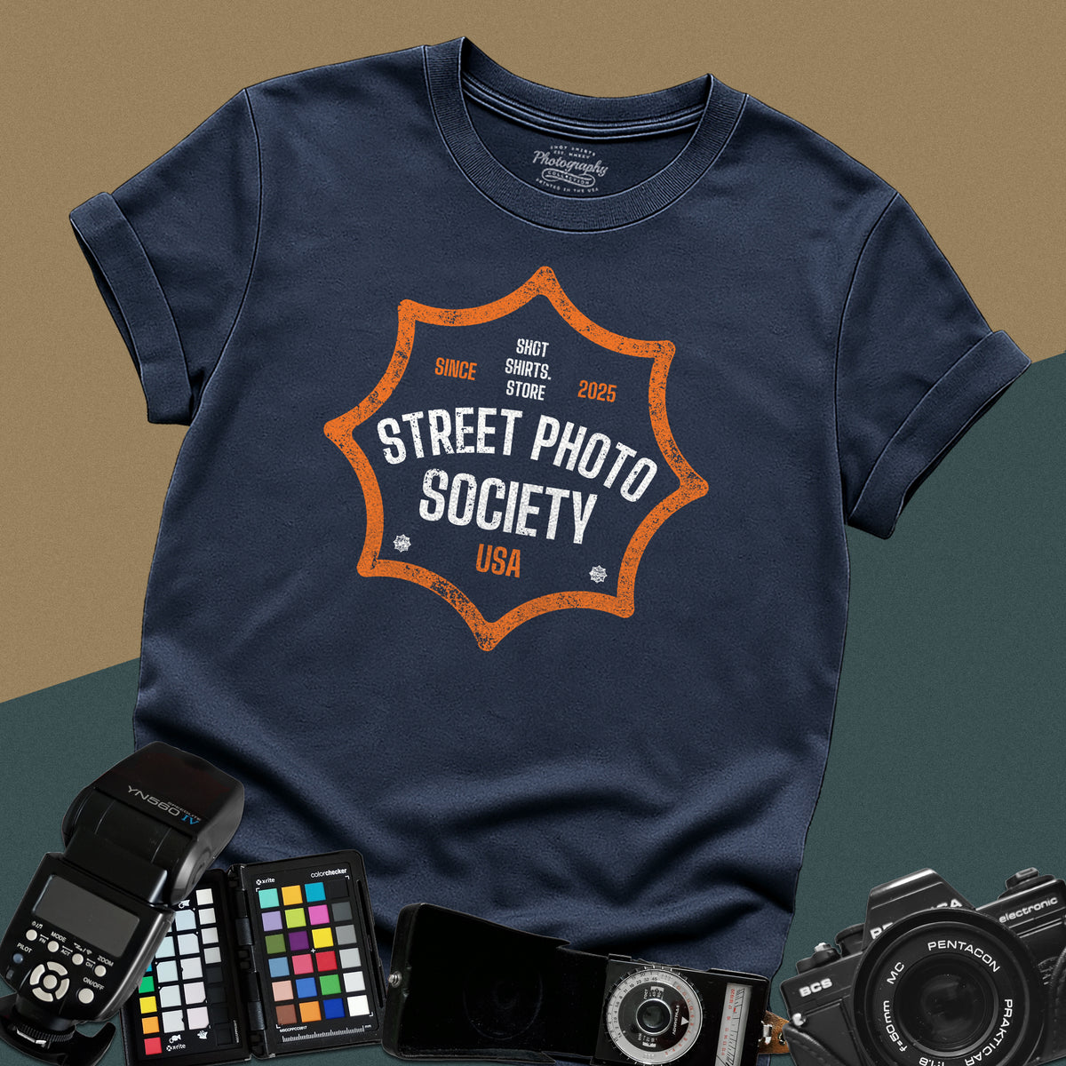 Distressed navy-blue t-shirt featuring a retro shield badge emblem with Street Photo Society USA typography for urban documentary photographers.