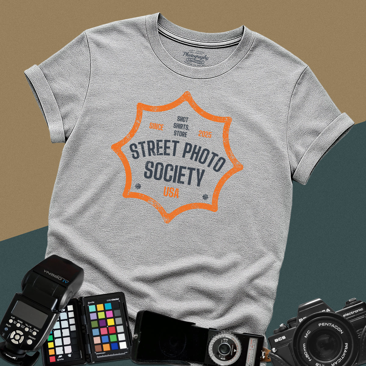 Distressed sport-grey t-shirt featuring a retro shield badge emblem with Street Photo Society USA typography for urban documentary photographers.