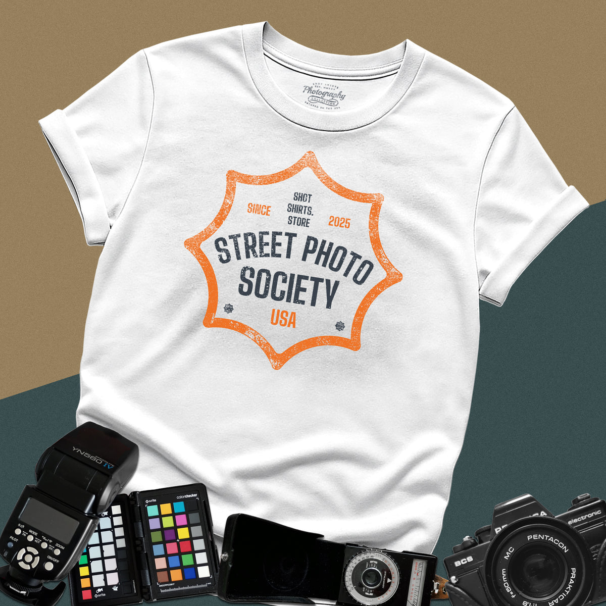 Distressed white t-shirt featuring a retro shield badge emblem with Street Photo Society USA typography for urban documentary photographers.